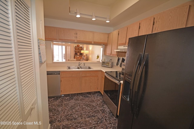 kitchen with stainless steel appliances, light countertops, light brown cabinetry, a sink, and under cabinet range hood