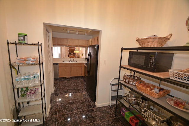 hall featuring a sink, baseboards, and granite finish floor