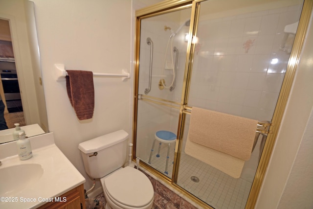 full bathroom with a stall shower, vanity, and toilet