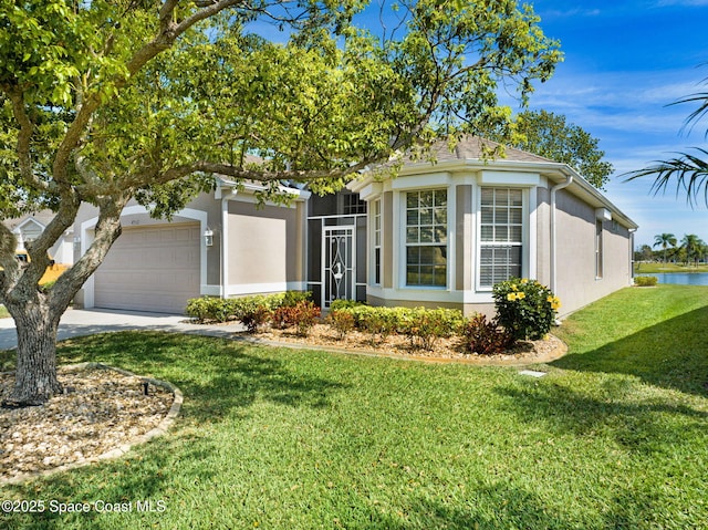 view of front of house featuring a front lawn, concrete driveway, a garage, and stucco siding