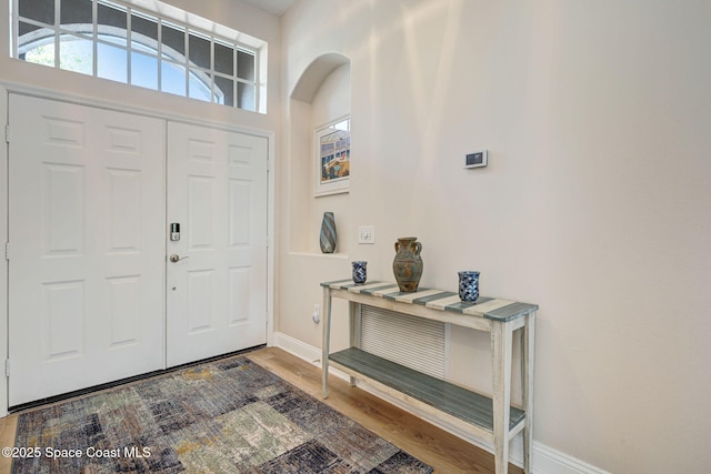 foyer with wood finished floors and baseboards