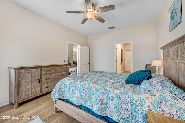 bedroom featuring visible vents, baseboards, light wood-type flooring, and ceiling fan