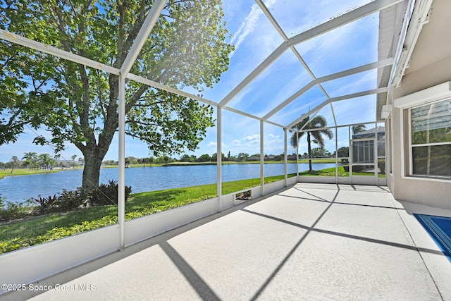 unfurnished sunroom featuring a water view