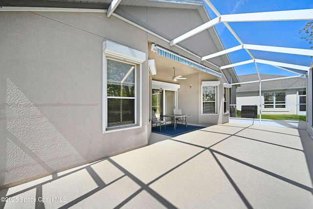 view of patio / terrace with outdoor dining space, a lanai, and ceiling fan