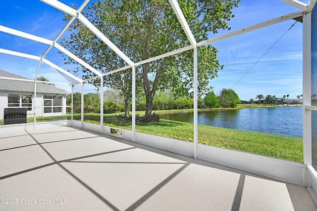 unfurnished sunroom featuring a water view