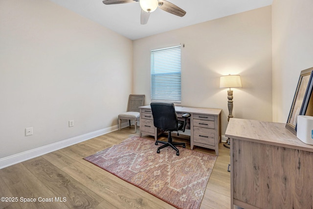 office with light wood-type flooring, baseboards, and a ceiling fan