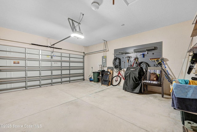 garage featuring electric panel and a garage door opener