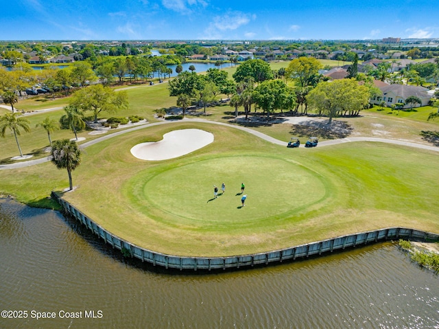 aerial view featuring view of golf course and a water view