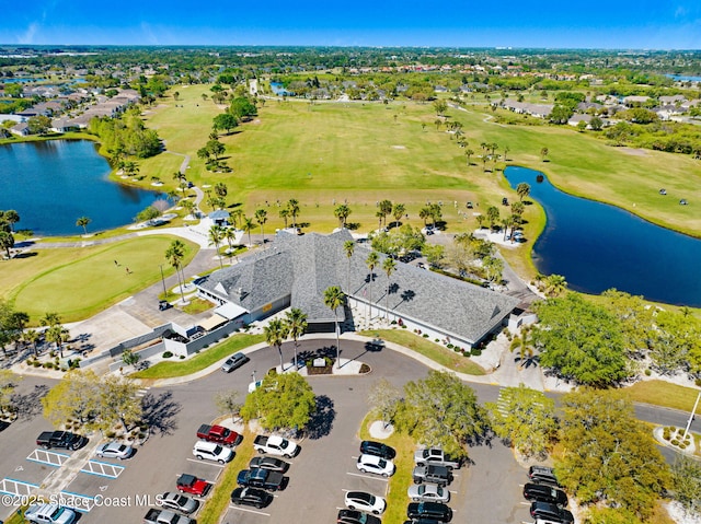 birds eye view of property with a water view and view of golf course