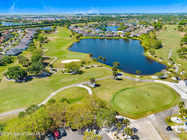 birds eye view of property with a water view and view of golf course