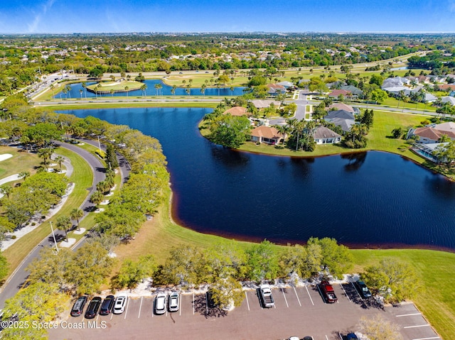 drone / aerial view with a water view and a residential view