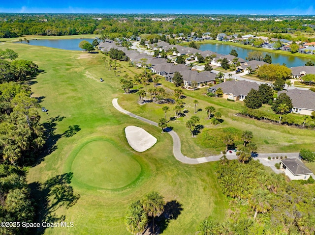 drone / aerial view featuring a residential view, golf course view, and a water view