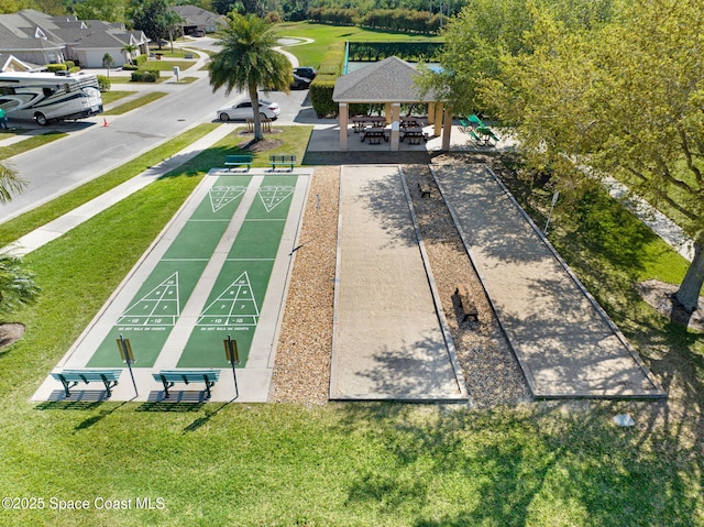 view of home's community with a gazebo, shuffleboard, and a yard