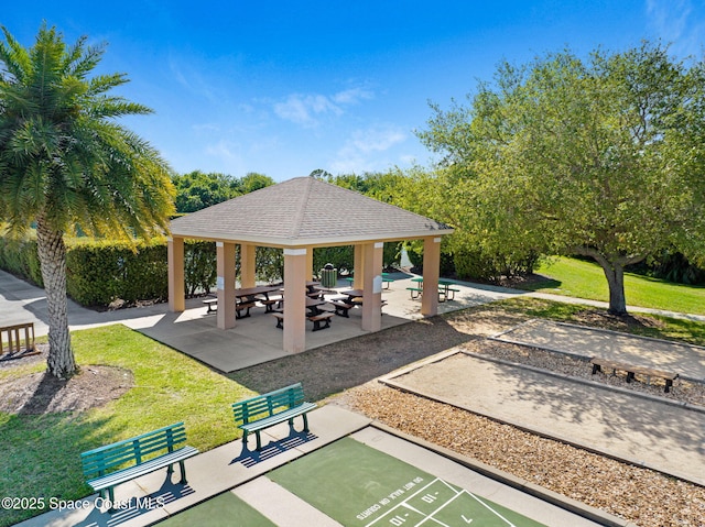 view of community featuring a gazebo, shuffleboard, and a yard