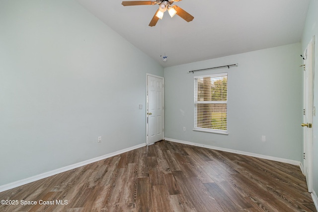 empty room with dark wood-style floors, ceiling fan, lofted ceiling, and baseboards