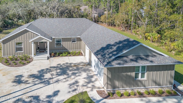 view of front of home featuring a shingled roof and board and batten siding