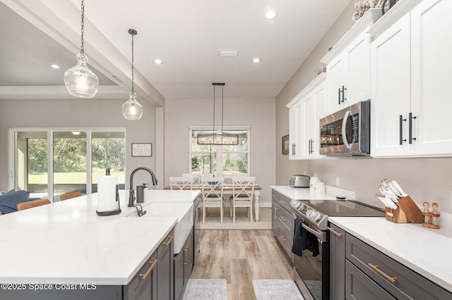 kitchen with light wood-style flooring, appliances with stainless steel finishes, white cabinets, and recessed lighting