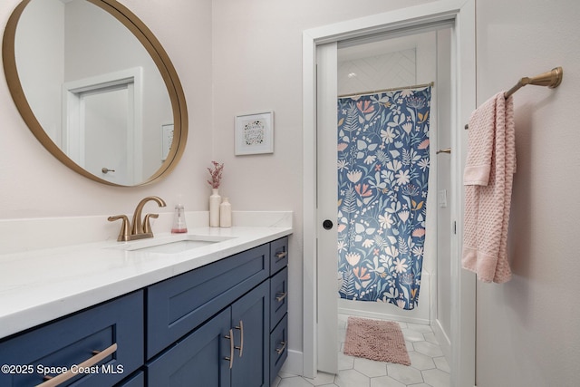 bathroom with a shower with curtain, tile patterned flooring, and vanity