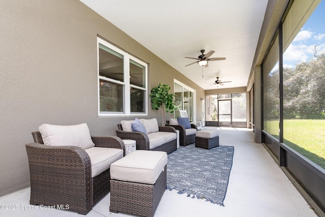 sunroom / solarium featuring a ceiling fan