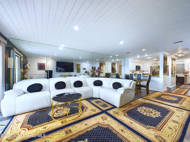 living room featuring ornate columns, visible vents, wood finished floors, and recessed lighting