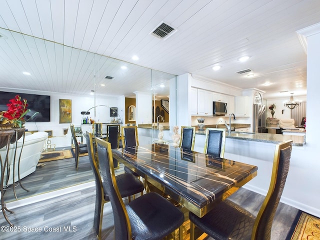 dining area with wooden ceiling, visible vents, dark wood-style flooring, and crown molding