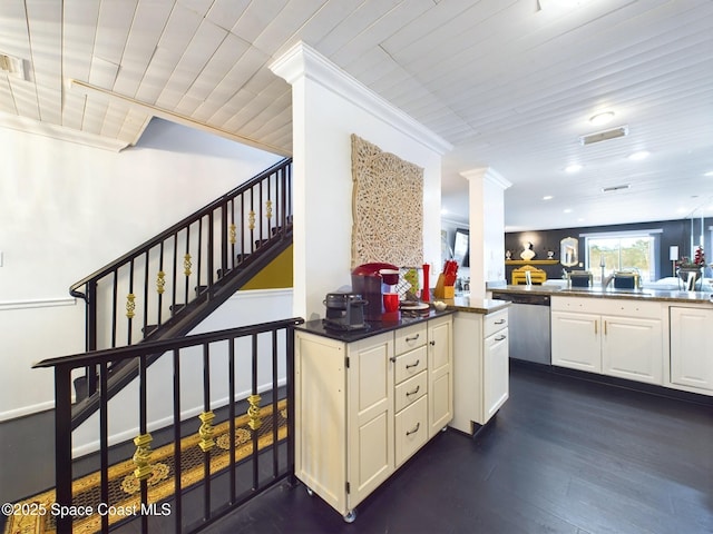 kitchen featuring dark wood finished floors, decorative columns, visible vents, stainless steel dishwasher, and a peninsula