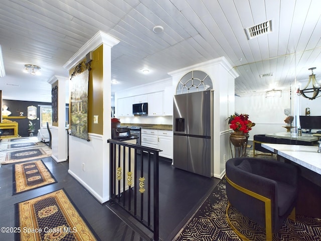 kitchen featuring visible vents, white cabinets, dark wood-style flooring, stainless steel appliances, and light countertops