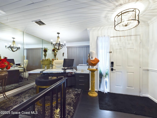 office with crown molding, visible vents, dark wood-style flooring, and a notable chandelier