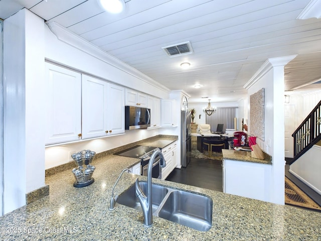 kitchen featuring crown molding, visible vents, appliances with stainless steel finishes, white cabinets, and a sink