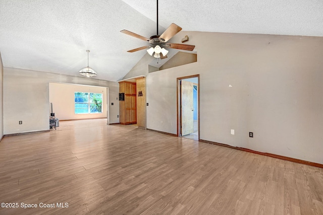 unfurnished living room with light wood-style flooring, a ceiling fan, and a textured ceiling