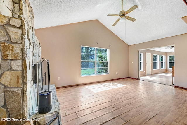 unfurnished living room with ceiling fan, a textured ceiling, and wood-type flooring