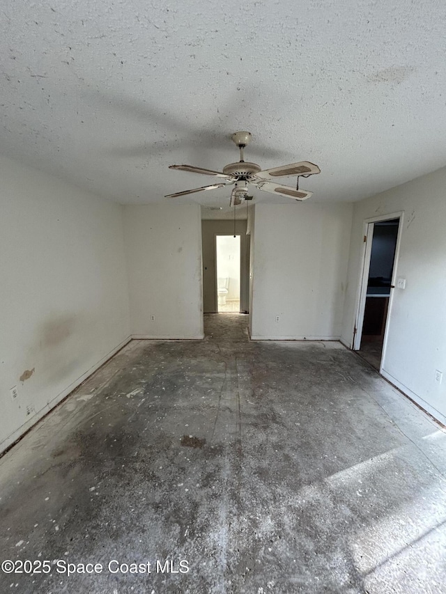 empty room featuring ceiling fan and a textured ceiling