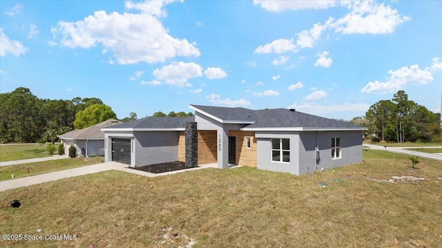 view of front of property featuring an attached garage, driveway, a front lawn, and stucco siding