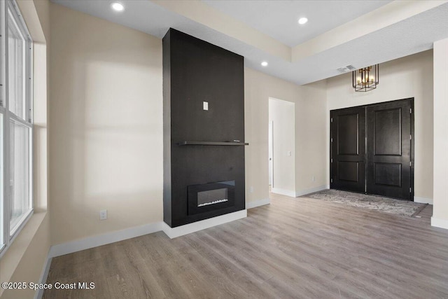 entrance foyer featuring light wood finished floors, visible vents, and baseboards