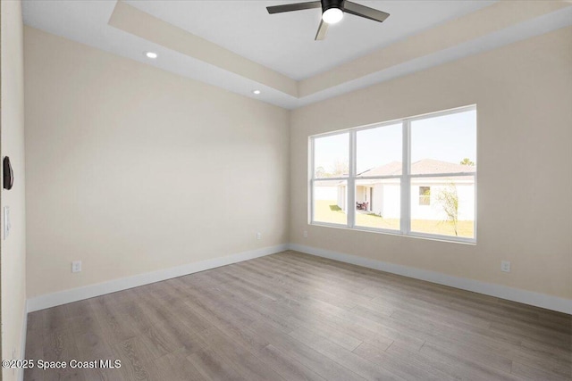 spare room with light wood-style flooring, baseboards, ceiling fan, and recessed lighting