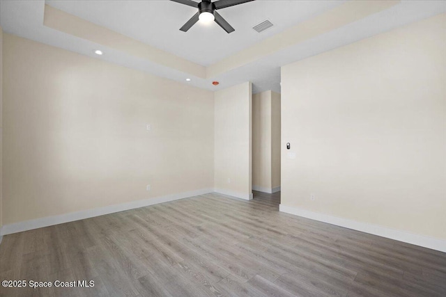 spare room with baseboards, visible vents, ceiling fan, light wood-style floors, and recessed lighting