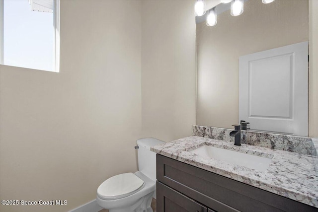 bathroom with toilet and vanity