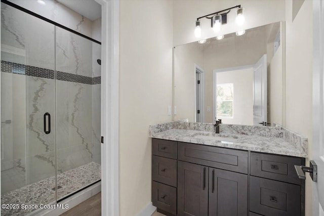 full bathroom featuring vanity and a marble finish shower