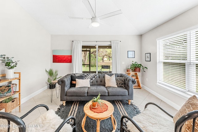 living room with lofted ceiling, light tile patterned floors, and baseboards