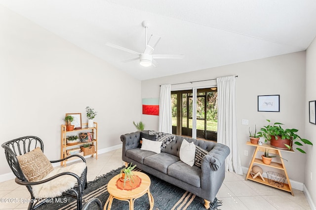 living area featuring a ceiling fan, light tile patterned flooring, vaulted ceiling, and baseboards