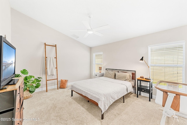 bedroom featuring a ceiling fan, lofted ceiling, light colored carpet, and baseboards