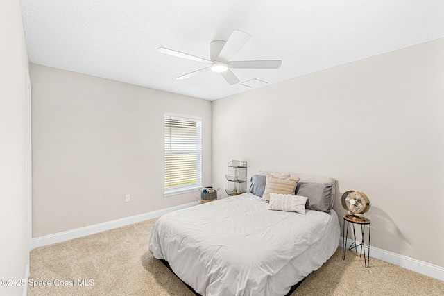 bedroom with carpet, visible vents, baseboards, and ceiling fan