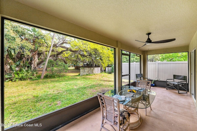 sunroom with a ceiling fan