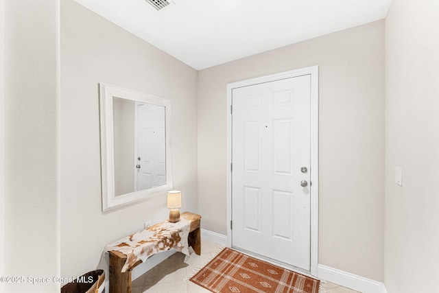 entryway featuring baseboards and light tile patterned flooring