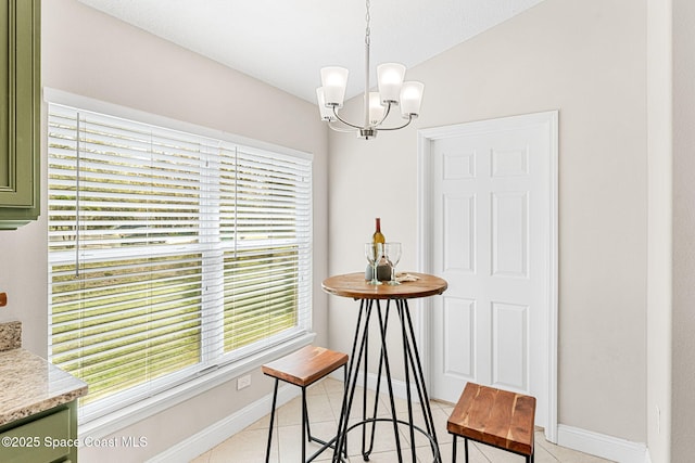 dining room with light tile patterned flooring, a notable chandelier, and baseboards