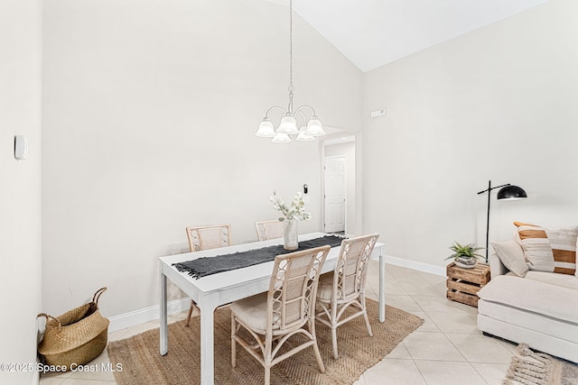 dining space featuring light tile patterned floors, high vaulted ceiling, baseboards, and an inviting chandelier