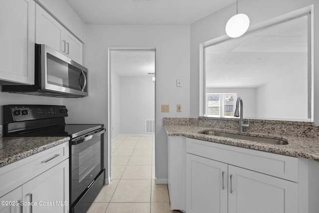 kitchen featuring visible vents, white cabinets, stainless steel microwave, black range with electric cooktop, and a sink