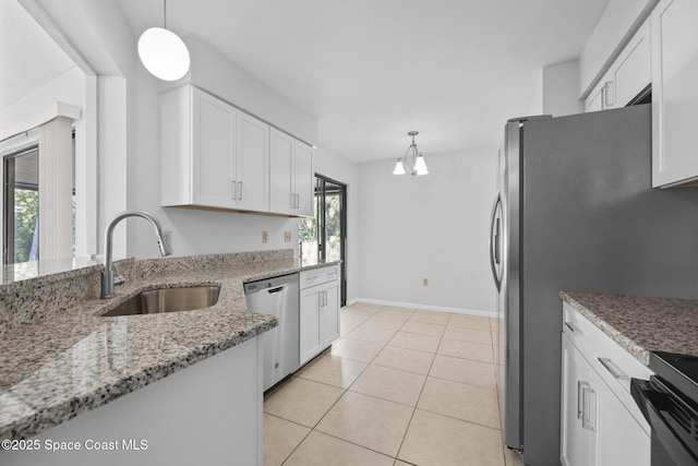 kitchen with hanging light fixtures, white cabinetry, stainless steel appliances, and a sink