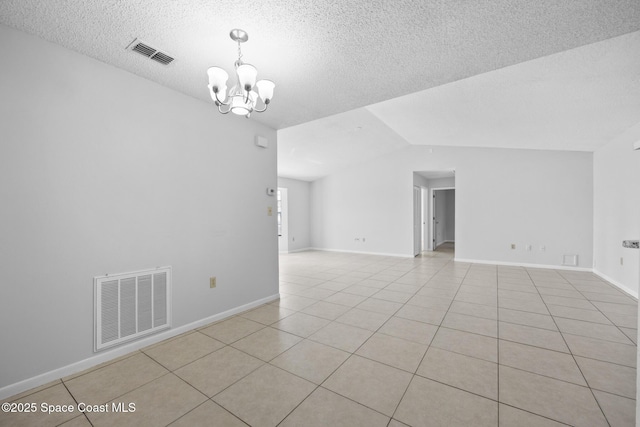 unfurnished room featuring visible vents, vaulted ceiling, a notable chandelier, and light tile patterned flooring