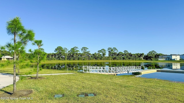 exterior space with a lawn and a water view